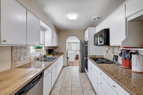 a large kitchen with white cabinets and appliances at 3 Bedrooms house in Marvelous Las Vegas in Las Vegas