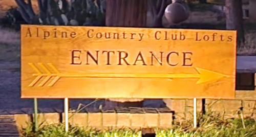 a sign that reads alpine country clubventures entrance at Alpine Country Club Lofts in Alpine