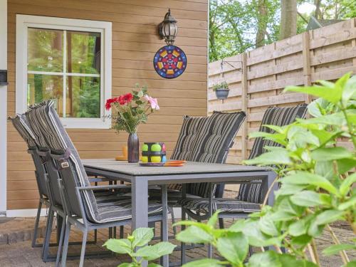 a patio with a table and chairs on a house at Zonnestroom in Meijel