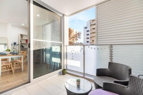 a balcony with two chairs and a table on a balcony at Stylish Comfort 1BR Apt w free P in Sydney