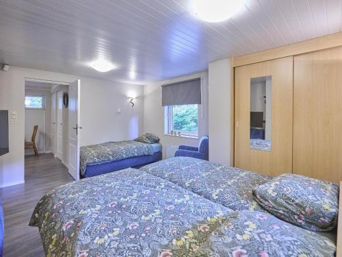 a bedroom with two beds and a room with a bed sqor at Zonnestroom in Meijel