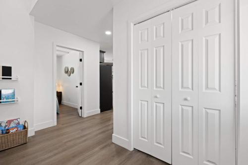 a white door in a room with a hallway at The River House in Three Rivers