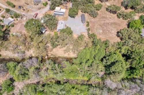 an overhead view of a yard with trees and a house at The River House in Three Rivers