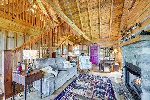 a living room with a couch and a fireplace at 2 Mi to Mabry Mill Mtn-View Cabin with Porch! in Meadows of Dan