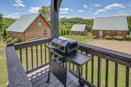 a camera sitting on a porch with a cabin at 2 Mi to Mabry Mill Mtn-View Cabin with Porch! in Meadows of Dan
