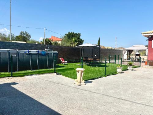 a fire hydrant on a sidewalk next to a fence at --CHALET EN ALICANTE-- Piscina Privada in Moralet