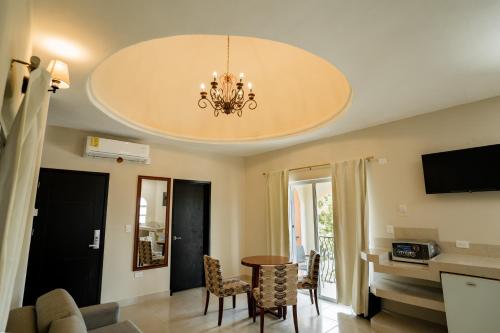 a living room with a dining room table and a chandelier at Gran SAHARA in Playa del Carmen