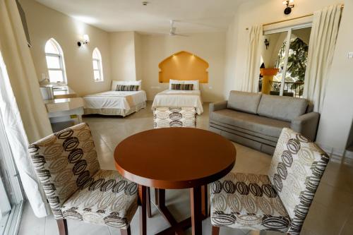 a living room with a couch and a table at Gran SAHARA in Playa del Carmen