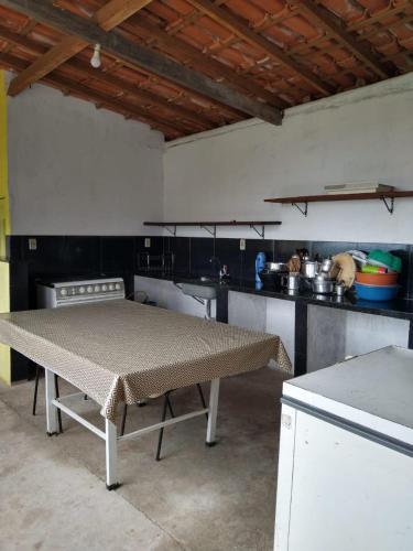 a kitchen with a table in the middle of it at Sítio topo do Vale in Sabará