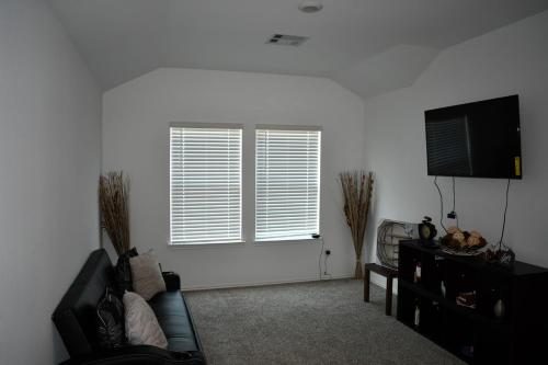 a living room with a couch and a window at Relitorin Sweet Home & Pool in Spring
