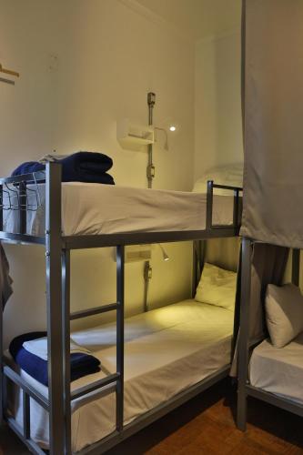 a couple of bunk beds in a room at Lamparina Hostel in Sao Paulo