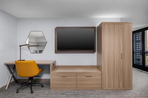 an office with a desk and a tv and a chair at Holiday Inn Express Hilton Head Island by IHG in Hilton Head Island