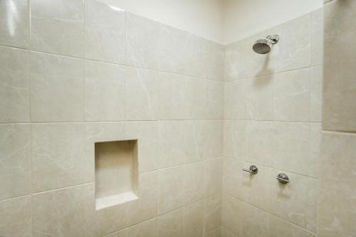 a bathroom with a shower with a large tile shower at Gran SAHARA in Playa del Carmen