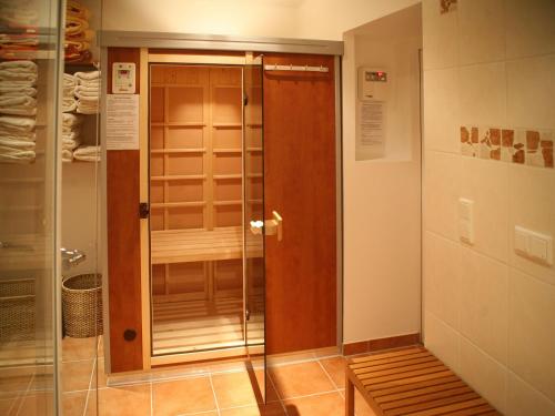 a shower with a glass door in a room at Worners Schloss Weingut & Wellness-Hotel in Prichsenstadt