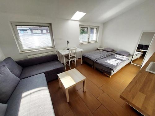 a living room with a bed and a couch at Bella Lubiana in Ljubljana