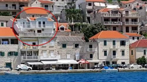 a red circle in the middle of a city with buildings at Apartments by the sea Povlja, Brac - 21810 in Povlja