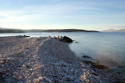 a rocky shore of a large body of water at Apartments by the sea Povlja, Brac - 21810 in Povlja
