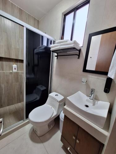 a bathroom with a toilet and a sink and a shower at Casa Coruña in Durango in Durango