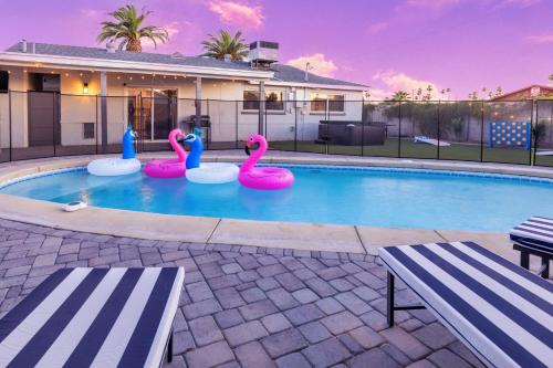 a swimming pool with pink flamingos in a house at Chic Scottsdale Escape with Pool in Scottsdale