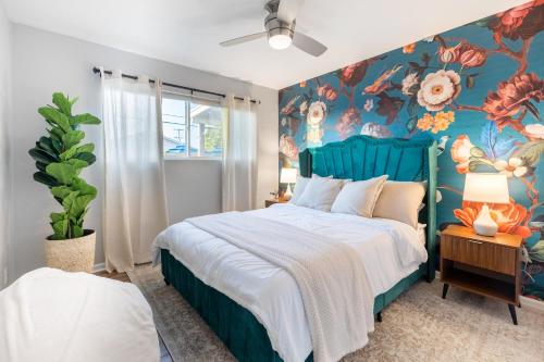 a bedroom with a blue bed with a floral wall at Chic Scottsdale Escape with Pool in Scottsdale