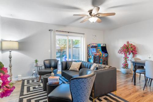 a living room with a couch and a ceiling fan at Chic Scottsdale Escape with Pool in Scottsdale