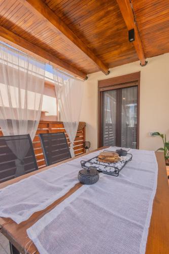 a room with a table with a blue blanket on it at The Neo-Classic Loft in Rhodes Town