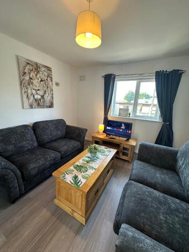 a living room with a couch and a coffee table at Newcastle Townhouse in Galway