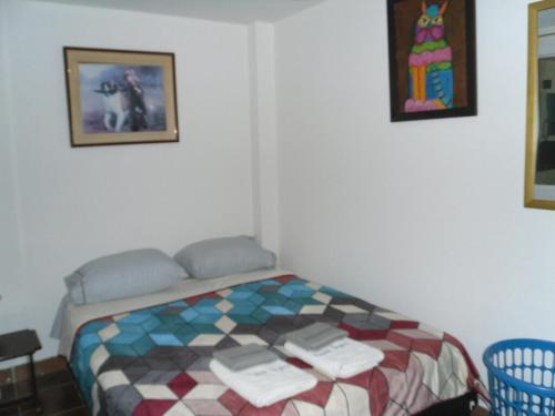 a bedroom with a bed with towels on it at Casa Inpro Resting place in Bogotá