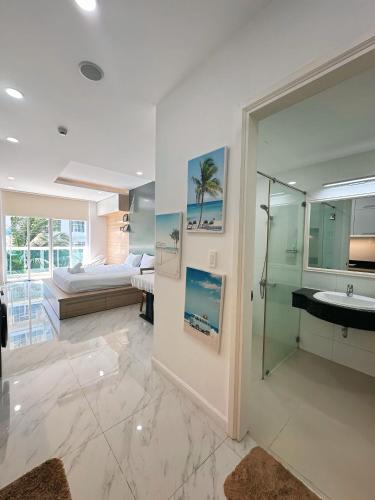 a bathroom with a shower and a sink and a bed at Ocean Vista Mai House in Ấp Phú Tịnh (2)
