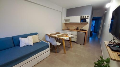 a living room with a blue couch and a table at Alojamientos Litoral - España 4 in Gualeguaychú