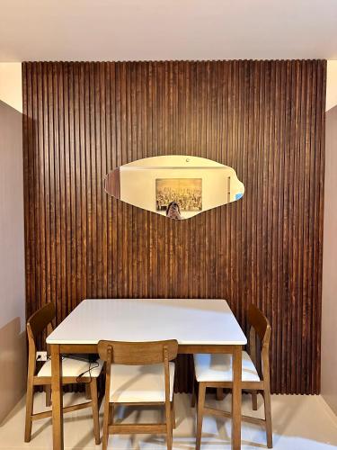 a table and chairs in front of a wooden wall at Tey Spot in Iloilo City