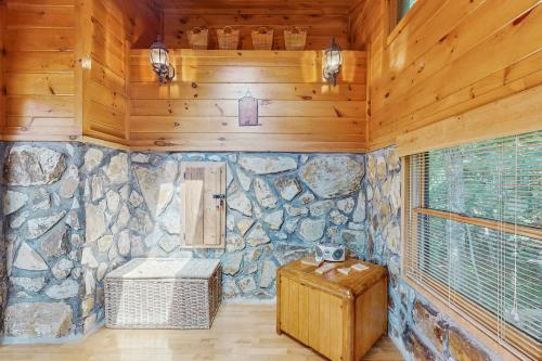 a room with a stone wall and a wooden ceiling at Time Out in Blue Ridge
