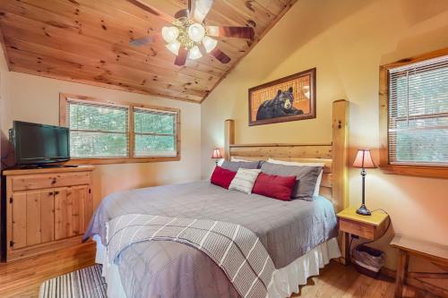 a bedroom with a bed and a flat screen tv at Time Out in Blue Ridge