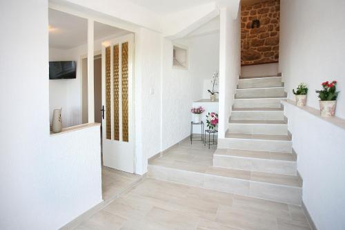 a staircase in a home with white walls and floors at Holiday Home Miklica in Klis
