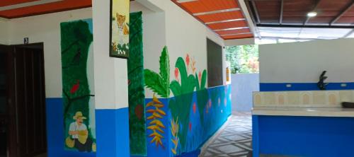 a room with a wall painted with animals and plants at Finca MI FUNDO in Acacías