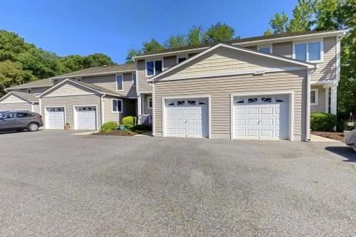 a house with three garages in a driveway at Salt Pond --- 38435 Mainsail Dr #9 in Bethany Beach