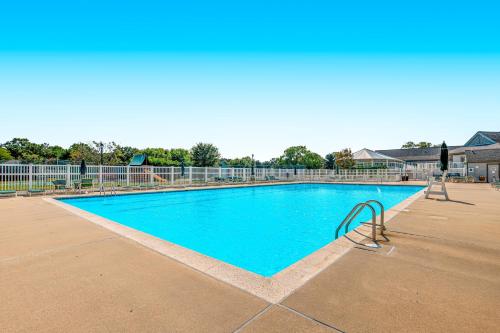 a large blue swimming pool in a building at Salt Pond --- 38435 Mainsail Dr #9 in Bethany Beach
