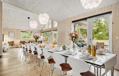 a long dining room with a long table and chairs at Holiday Home Frederiksværk With Fireplace 10 in Frederiksværk