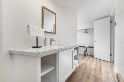 a white bathroom with a sink and a mirror at Mountain Nook CN Lodge #4 in Ponderosa