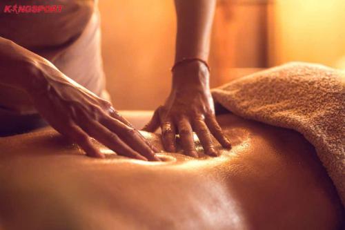 a person with their hands on top of a blanket at Astica Hotel Nha trang in Nha Trang