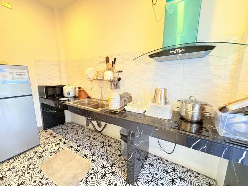 a kitchen with a counter top with dishes on it at Medina Private Pool Villa-บางแสน in Ban Puk (1)
