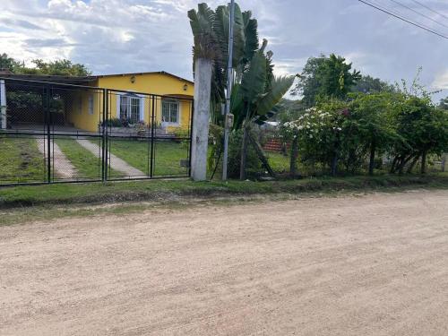 a fence in front of a yellow house at Poptún, Peten home accommodation in Ixobel
