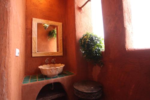 a bathroom with a sink and a mirror at Jialeshuel Surf house B&B in Manzhou