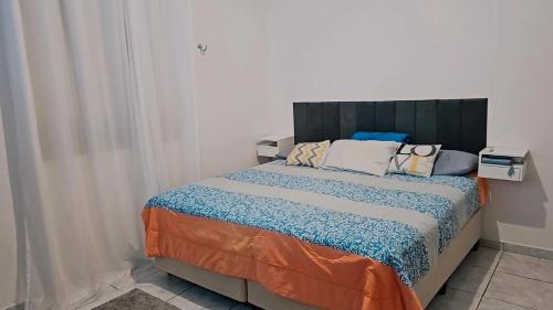 a bedroom with a large bed in a room at Chácara Cop 30 in Marituba