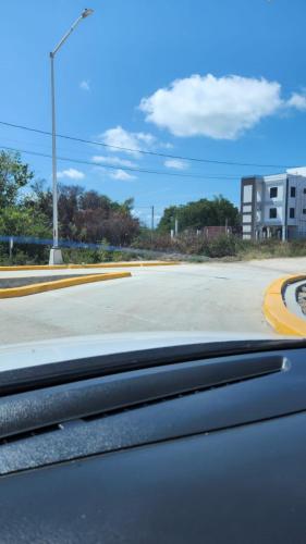 a view of a street from the windshield of a car at See Belize WATERSIDE Sea View Apt for 6 with Kitchen, Balcony, Infinity POOL & Overwater Deck, 2nd Floor in Belize City