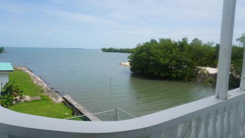 a view of a body of water from a balcony at See Belize WATERSIDE Sea View Apt for 6 with Kitchen, Balcony, Infinity POOL & Overwater Deck, 2nd Floor in Belize City