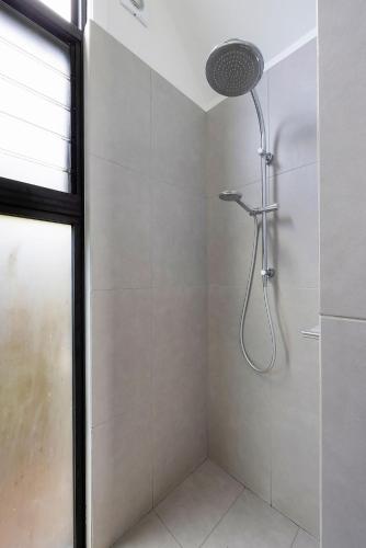 a shower with a shower head in a bathroom at Reflections Seal Rocks - Holiday Park in Smiths Lake
