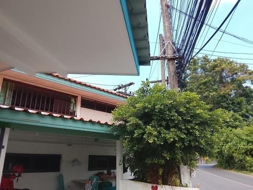 a building with a tower on the side of a street at Waiting you come in Phuket Town