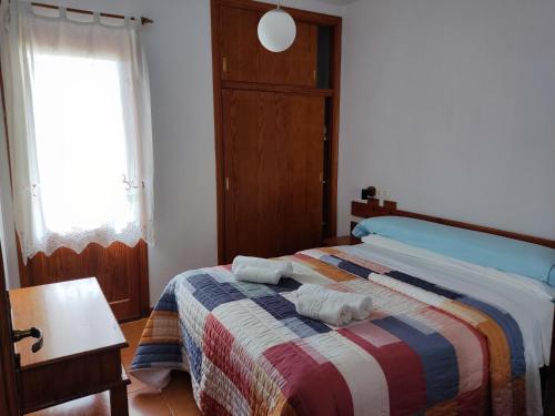 a bedroom with a bed with two towels on it at Bosc i Sol VT in Es Calo