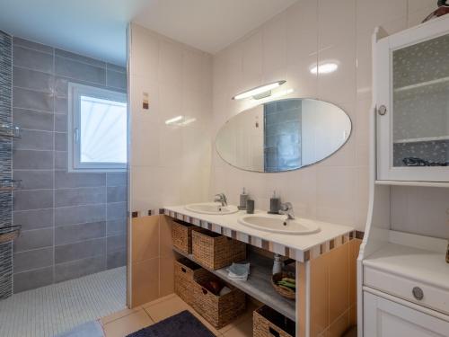 une salle de bain avec un lavabo et un miroir dans l'établissement Maison spacieuse à 600m du lac, 8 pers., piscine - FR-1-50-161, à Aureilhan